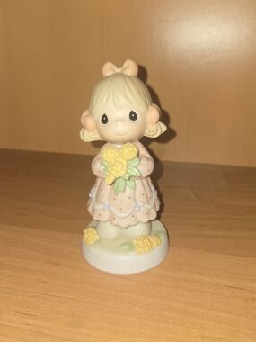 Precious Moments Girl Figurine Holding Yellow Flowers in Pastel Pink